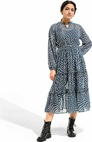 Blue, long, woven dress featuring a round neck with frill and back slit opening. It has an overall print in a contrasting colors along with straight sleeves with elastic. It also has cut and sew panels with frills.  The model...