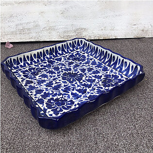 This ceramic blue dish has a very unique square shape. It has lifted corners and is hand painted in traditional yet intricate pattern. The stoneware is handcrafted by the skilled artisans of Multan. This unique master piece can be used to...