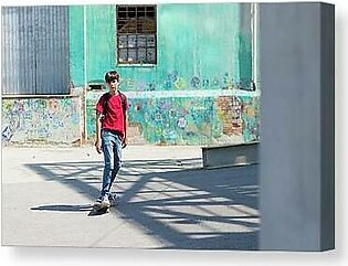 Full Length Of Student Skateboarding On Road In City During Sunny Day Canvas Print