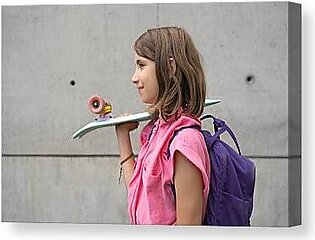 Teenage Girl Carrying Skateboard On Shoulder Outdoors Canvas Print
