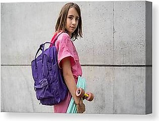 Tennage Girl With A Skateboard And Schoolbag Looking At Camera Canvas Print