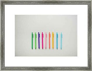 Colorful Pens Lined Up On Plain White Table Framed Print