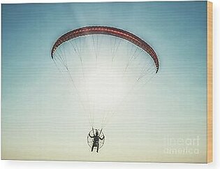Paraglider in the air, beautiful blue sky in the background. Wood Print
