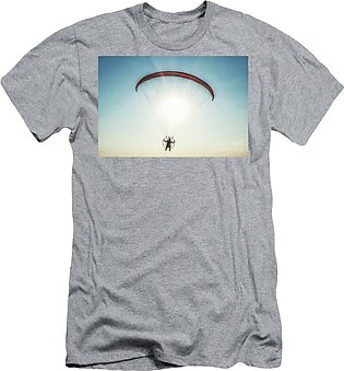 Paraglider in the air, beautiful blue sky in the background. T-Shirt